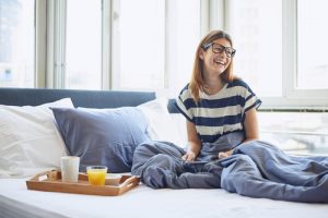 Woman Sitting On Bed