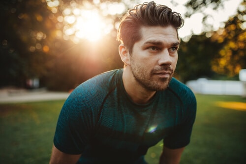 portrait of healthy young man standing outdoors in park and looking away-img-blog.