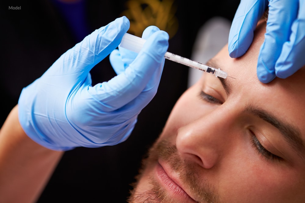 Man undergoing a BOTOX® Cosmetic injection on his forehead.